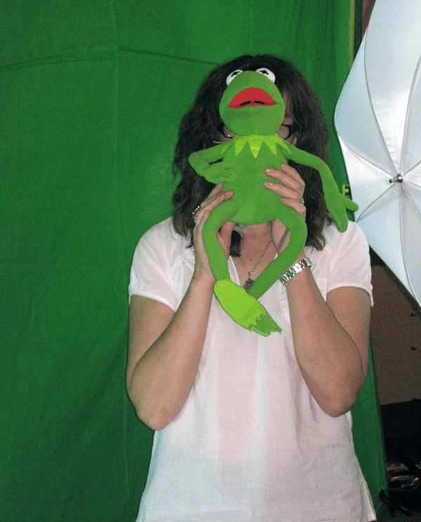 Wendy holding up Kermit the Frog